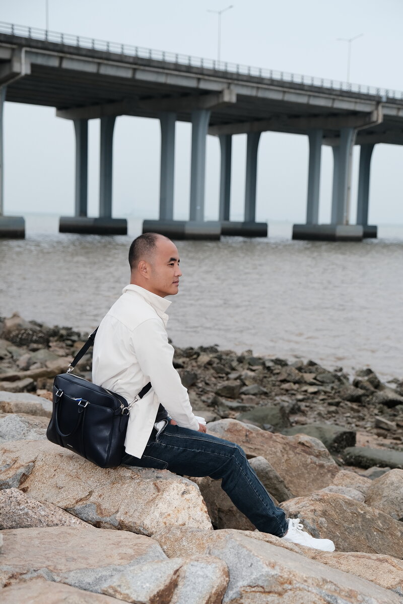 Sitting on rocks, professional look by the water