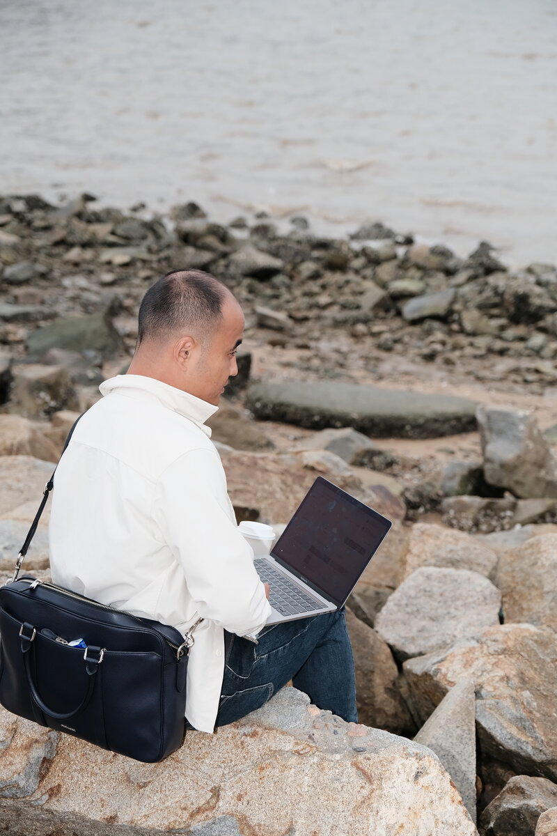 Cinematic wide shot, arms outstretched facing the horizon with bridge